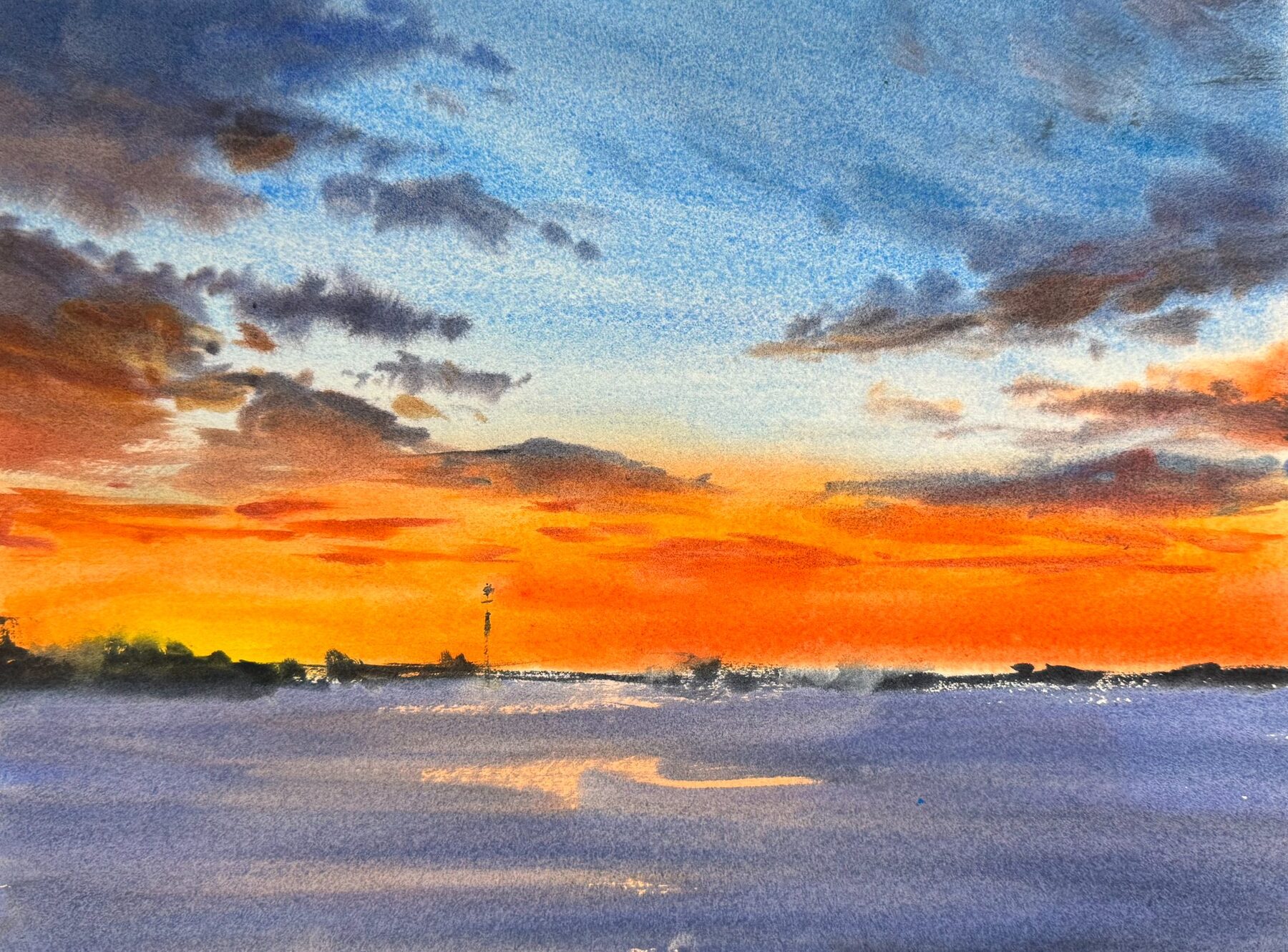 Orange winter sun over frozen water and a low horizon.